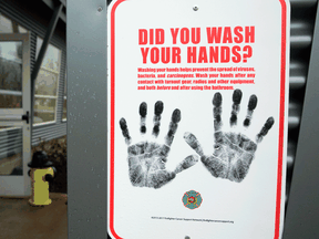 A sign reminding people to wash their hands outside a dormitory designated as a 2019 novel coronavirus quarantine site in North Bend, Washington.