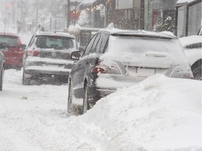 Vehicles move through snow-covered streets as a snowstorm hits the province Friday, February 7, 2020 in Quebec City.