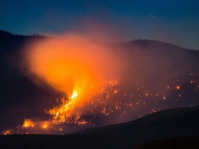 A wildfire burns on a mountain near Ashcroft, B.C., July 7, 2017.