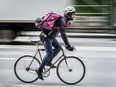 A Foodora delivery cyclist makes his way across Bloor Street at Yonge Street in Toronto recently.