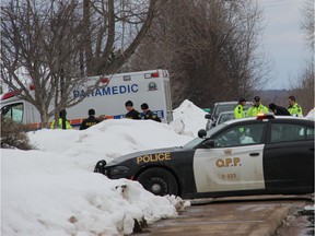 Officers from the Upper Ottawa Valley OPP detachment and paramedics with the County of Renfrew Paramedic Services at the scene of a fatal collision between a pedestrian and a pick-up truck in a parking lot in Pembroke on Thursday, March 5. Anthony Dixon