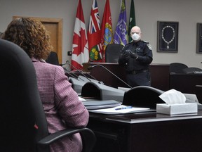 Cornwall police Staff-Sgt. George Knezevic demonstrates protective equipment at the city's police services board.