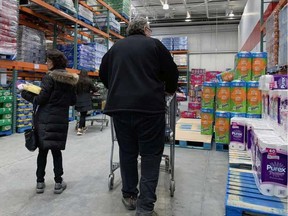 Calgary Costco customers shop for paper products on Tuesday, March 3.