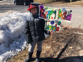 Lincoln Ouellette stands outside his house in Kanata after a drive-by birthday celebration replaced earlier plans for his ninth birthday  party, which was canceled due to the COVID-19 pandemic.