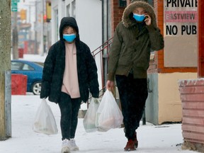 OTTAWA -- Monday, Mar. 23, 2020 -- Pedestrians on Somerset Street in Ottawa wear masks but don't social distance during the  COVID-19 outbreak.