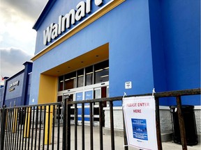 Barricades and signs restrict shoppers at Brockville's north-end Walmart store to one entrance on Tuesday evening.