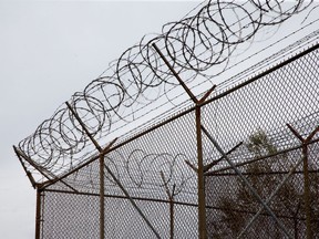 Barbed wire tops the fences of the Ottawa Carleton Detention Centre. Not much 'social distancing' in jail.