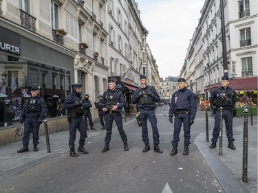 Police officers patrol the streets after a government enforced quarantine on Tuesday in Paris, France.