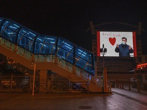 A large monitor shows an image of Chinese president Xi Jinping wearing a mask in the nearly empty Beijing Station on March 13, 2020 in Beijing, China.