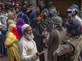 NEW DELHI, INDIA - MARCH 24: Indian Muslims argue with a group of Indian police men after they were removed from the protest site,  amid a nationwide lockdown over highly contagious novel coronavirus at Shaheen Bagh area  on March 24, 2020 in Shaheen Bagh area of Delhi, India. Amid a nationwide lockdown over highly contagious novel coronavirus, Shaheen Bagh, which was the epicenter of anti-citizenship law protests in India since December 15 last year was cleared by the Delhi police after 101 days. Thousands of Indian policemen reached the site of the protest - which had inspired similar demonstrations across India- and forcefully removed and detained some women protesters after the dissenters refused to move out.