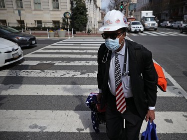 Robert Lee of the District of Columbia walks through the Penn Quarter of the city, which is mostly empty of vehicle traffic and pedestrians due to the coronavirus outbreak.