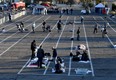 People arrive at a temporary homeless shelter set up in a parking lot at Cashman Center on March 30, 2020 in Las Vegas, Nevada.