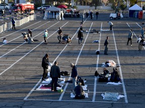 People arrive at a temporary homeless shelter set up in a parking lot at Cashman Center on March 30, 2020 in Las Vegas, Nevada.