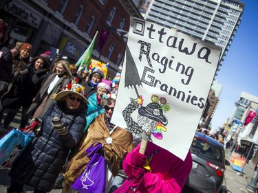 Those taking part in Saturday's march for International Women's Day make their way from Parliament Hill to city hall.