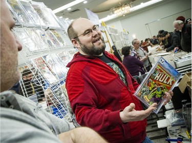 The Capital Comic Book Convention was held at the Delta hotel Sunday March 8, 2020. Ben Gosselin, left, and Robin Kenny talk about the Incredible Hulk comic that is the highest priced comic they were selling in their booth Sunday.   Ashley Fraser/Postmedia