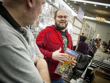 The Capital Comic Book Convention was held at the Delta hotel Sunday March 8, 2020. Ben Gosselin, left, and Robin Kenny talk about the Incredible Hulk comic that is the highest priced comic they were selling in their booth Sunday.   Ashley Fraser/Postmedia