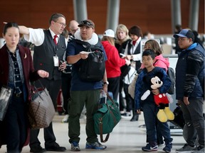 Travellers make their way through Ottawa International Airport on Wednesday, March 11, 2020.