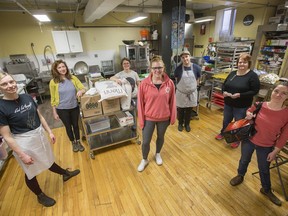 Today's group of workers on hand at the Parkdale Food Market includes (from left) Anna March, Heather Bruce, Tamara Kalnins, Meagan McVeigh, Simon Bell, Deb Abbot and Alissa Campbell.  The agency has changed the style of food service to a delivery and pick-up model rather than a shopping style of getting food into the community. Photo by Wayne Cuddington / Postmedia