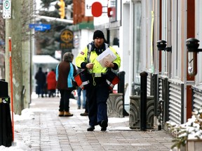 A Canada Post letter carrier on his rounds Tuesday during the COVID-19 pandemic.