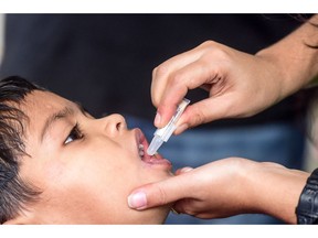A child receives an oral cholera vaccine from a health worker during a vaccination campaign in Dhaka on Feb. 19. It was part of a start of a global campaign to eliminate cholera in the world by 2030.