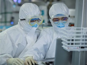 This photo taken on February 24, 2020 shows doctors working as they treat patients infected by the COVID-19 coronavirus at a hospital in Wuhan in China's central Hubei province. - The new coronavirus has peaked in China but could still grow into a pandemic, the World Health Organization warned, as infections mushroom in other countries.