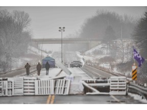 In this photo from February, protesters walk past their barricade on Highway 6 near Caledonia, Ont. Canada needs to fix the relationship with First Nations, but does that mean the country itself is in crisis?