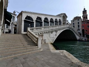 A picture shows the deserted Venice Rialto bridge in Venice on March 5, 2020. Italy closed all schools and universities until March 15 to help combat the spread of the novel coronavirus.