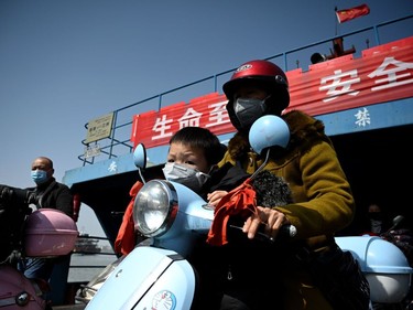 Passengers wearing face masks ride a boat across the Yangtze river to Jiangzhou township in Jiujiang in Chinas central Jiangxi province across from Hubei province which has been the epicentre of the country's COVID-19 coronavirus outbreak on March 14, 2020. - China reported 11 new infections of the coronavirus on March 14, and for the first time since the start of the epidemic the majority of them were imported cases from overseas.  The National Health Commission said there were four more people infected in Hubei's capital Wuhan, where the virus first emerged in December.