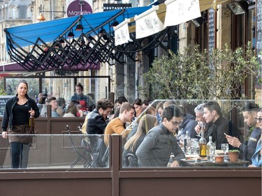 People sit on the terrace of a cafe in Bordeaux amid the outbreak of COVID-19, caused by the novel coronavirus, on March 14, 2020 and despite the authorities' recommendations to limit gatherings.