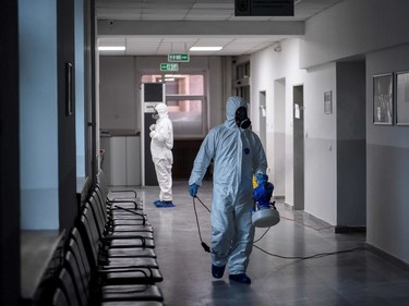 Workers disinfect the municipality building of Pristina on March 14, 2020. - Kosovo reported its first coronavirus cases on March 13, 2020  in a 22-year-old Italian woman and a 77-year-old Kosovar man, both recently returned from Italy.