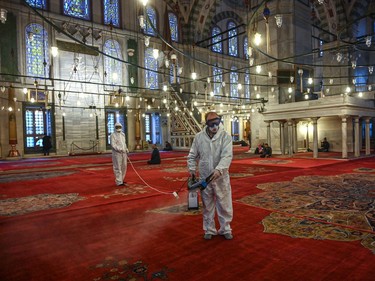 Municipal workers disinfects the Fatih mosque in Istanbul as part of measures to limit the spread of COVID-19, the novel coronavirus, on March 14, 2020. - Turkey will halt flights with nine European countries the transport minister said on March 13, after having already shut all schools for two weeks and bar spectators from football matches through April, as part of Ankara's bid to contain the spread of the new coronavirus.