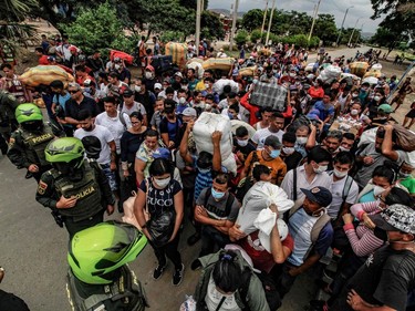 Venezuelan citizens try to enter Colombia while wearing protective face masks to prevent the spread of Coronavirus, in Cucuta, Colombia, on March 15, 2020.