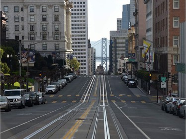 A San Francisco street usually filled with iconic cable cars is mostly empty as millions of residents were ordered to stay home to slow the spread of the deadly coronavirus.