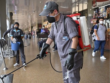 A worker disinfects an area of Bogota's bus terminal as a precautionary measure against the spread of the new coronavirus, COVID-19.