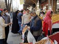 Not much social distancing: Iranians, some wearing protective masks, gather around the grand bazaar in Tehran on March 18.