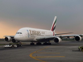 (FILES) A file photo taken on July 25, 2016 shows an Emirates Airlines Aibus A380-800 taxid on the runway of Bangkok's Suvarnabhumi airport. - Dubai carrier Emirates Airline announced on March 22, 2020 it will suspend all passenger flights from March 25 amid the novel coronavirus outbreak. "Today we made the decision to temporarily suspend all passenger flights by 25 March 2020," the airline said on Twitter. The United Arab Emirates announced on Friday the first two deaths from the COVID-19 disease in the country.