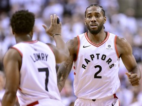 Toronto Raptors forward Kawhi Leonard (2) and teammate Kyle Lowry (7) celebrate a basket during first half NBA Eastern Conference playoff action against the Philadelphia 76ers, in Toronto on Saturday, April 27, 2019.