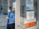 A security guard wears a protective mask in front of the new COVID-19 clinic at the site of the former Hotel Dieu hospital, March 9, 2020 in Montreal.