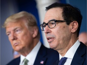 Steven Mnuchin, U.S. Treasury secretary, right, speaks beside U.S. President Donald Trump during a Coronavirus Task Force news conference in the briefing room of the White House in Washington, D.C., U.S., on Tuesday, March 17, 2020. Mnuchin said the administration is pushing to send direct payments to Americans within two weeks.