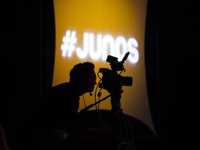 A videographer looks through his camera during the 2020 Juno Award nominee press conference in Toronto on Tuesday, January 28, 2020. Canadian music's Juno Awards, which were scheduled for Sunday in Saskatoon, have been cancelled as a precaution due to the COVID-19 pandemic.