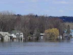 Homes along the Ottawa River in Gatineau, Que. are flooded on Tuesday, April 30, 2019. Flood prone regions across the country are bracing to fight emergencies on multiple fronts as they plan for rising water and rising cases of COVID-19.