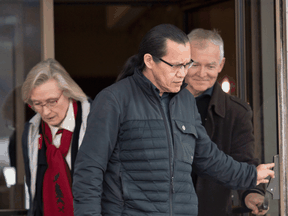 Wet'suwet'en hereditary leader Chief Woos, centre, Crown-Indigenous Relations Minister Carolyn Bennett, and B.C. Indigenous Relations Minister Scott Fraser arrive to speak to reporters in Smithers, B.C., March 1, 2020.