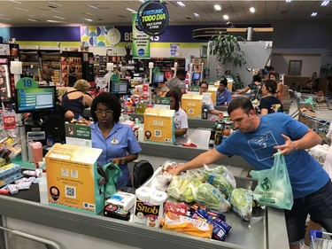 A man packs his goods in a supermarket one day after Brazilian authorities announced measures due to the coronavirus outbreak, in Rio de Janeiro, Brazil, March 14, 2020.