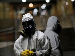 Members of the armed forces wearing protective suits are seen before disinfecting the Metro's Central station, amid coronavirus disease (COVID-19) outbreak, in Brasilia, Brazil, March 29, 2020.