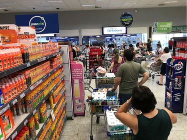 People line in a supermarket one day after Brazilian authorities announced measures due to the coronavirus outbreak, in Rio de Janeiro, Brazil, March 14, 2020.