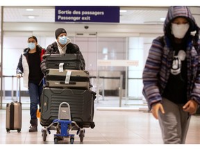 Canadians return from being stranded in Morocco due to flight restrictions imposed to help slow the spread of COVID-19, at Montreal-Trudeau International Airport in Montreal on Monday.