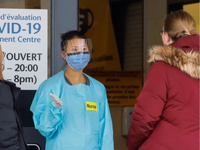 A nurse speaks to members of the public outside a coronavirus disease (COVID-19) assessment centre in Ottawa on March 25.