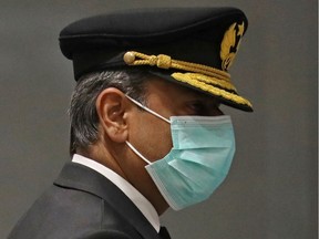 A pilot wearing a mask arrives, amid growing global numbers of coronavirus cases, at the international lounge at Pearson Airport in Toronto, Ontario, Canada March 15, 2020.
