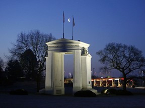 File photo/ The moon sets over the Peace Arch border crossing, in Surrey, British Columbia.