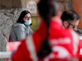 A woman wearing a protective mask waits to donate blood after appeals from hospitals and the Italian government for blood donations to help treat coronavirus patients, at an Italian Red Cross centre, in Rome, Italy March 17 2020.